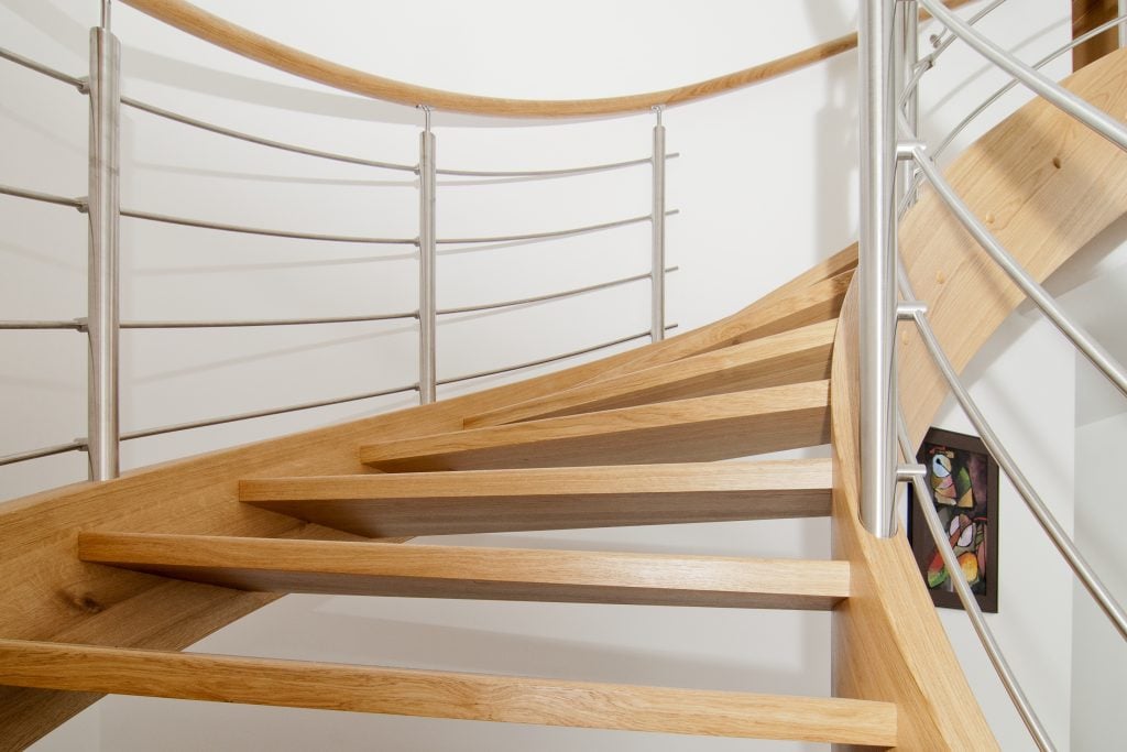 Curved wooden staircase with stainless steel elements