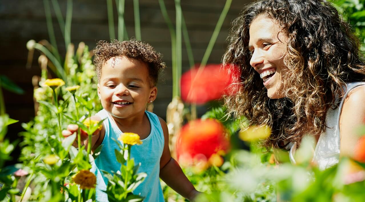 mother and child in home vegetable garden