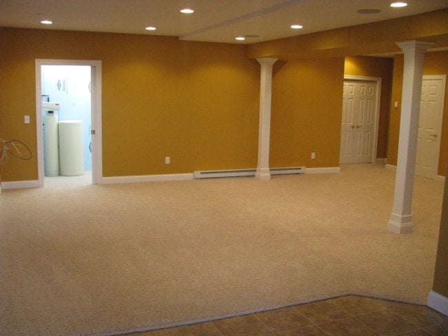 What is the best way to add a fridge to my basement that is fully carpeted?  Should I just put something underneath it or remove the carpet and put some  other type