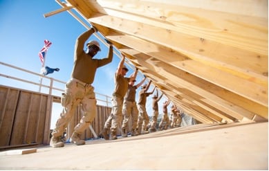 Contractors pushing up a wall