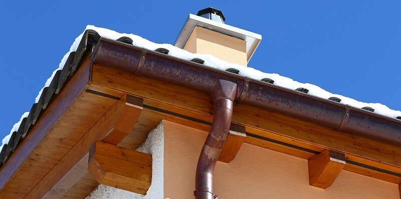 copper gutter off a snowy, residential roof