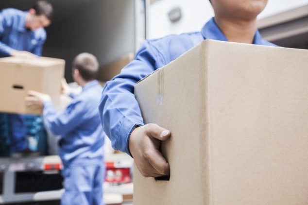 three professional movers unload a truck