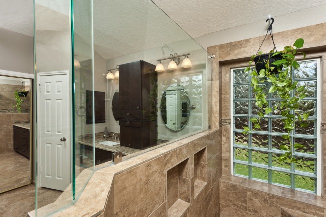 Bathroom wall with glass block tiles and mirror