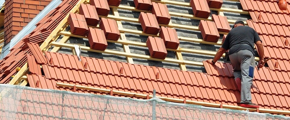 professional roofer installing tiles