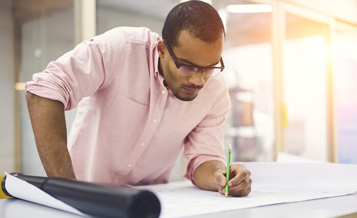 structural engineer at drawing table with plans