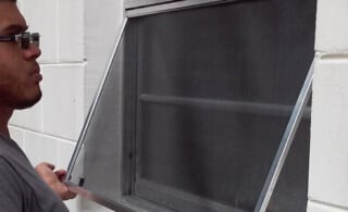 Man Installing a Window Screen