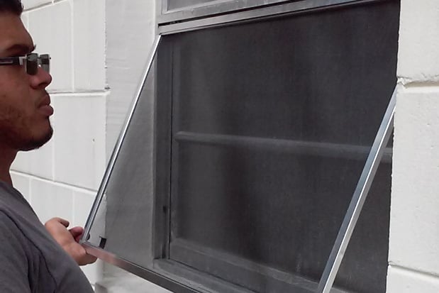 Man Installing a Window Screen