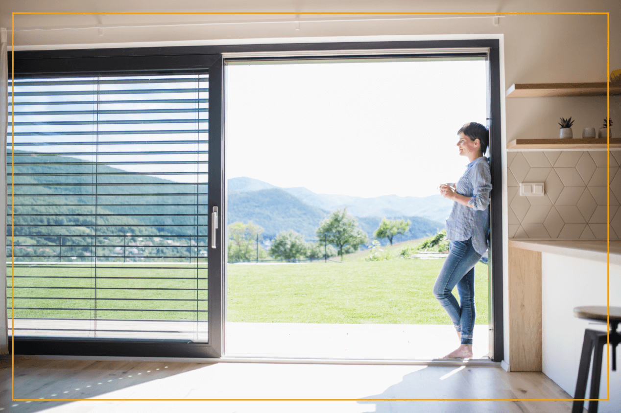 woman looking outside sliding glass window