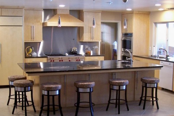 Kitchen with stainless steel backsplash