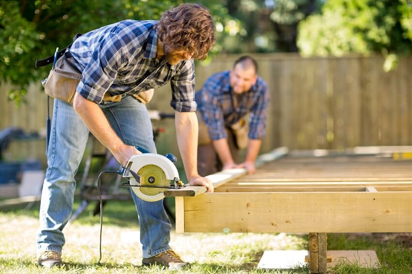 two professional deck builders at work