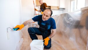 Senior home painters painting the walls in client's apartment