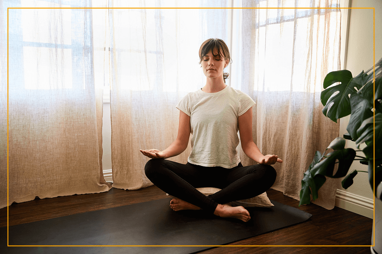 woman in meditation pose on floor