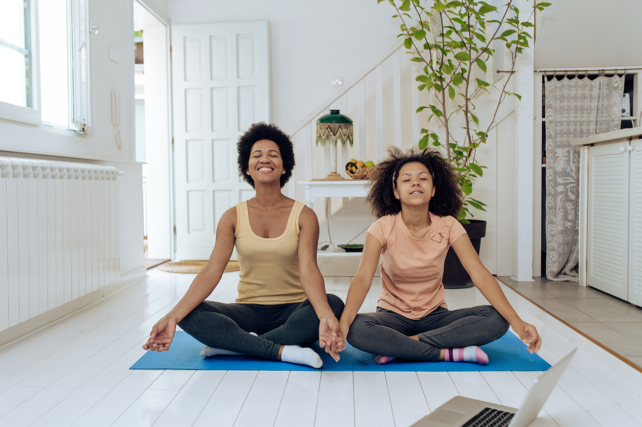 mother and daughter meditation on floor