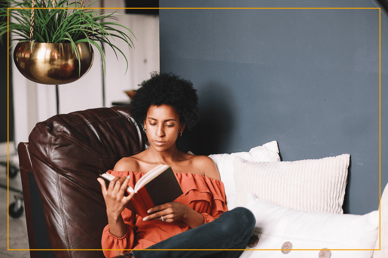 woman reading against blue accent wall