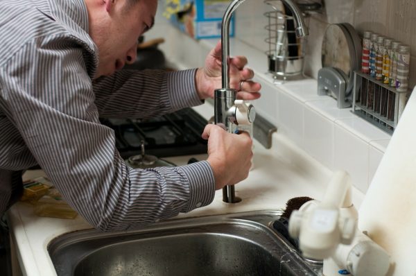 Plumber working on a sink