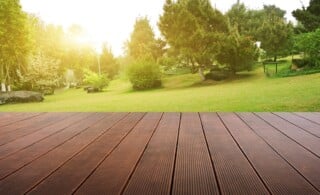 Wooden plank stage platform in a lush backyard