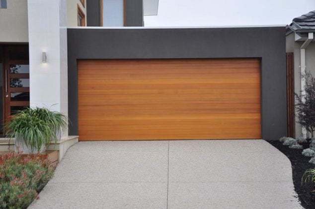 Modern, natural garage door in geometric, color block house