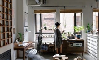 woman in small, crowded but organized condo