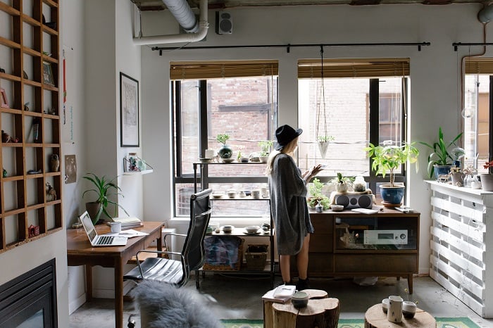 woman in small, crowded but organized condo