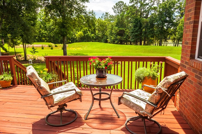 Backyard deck overlooking lake outside residential structure