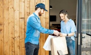 Errand service person bringing bags in to client