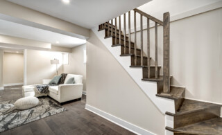 Open staircase leading to a nicely finished basement
