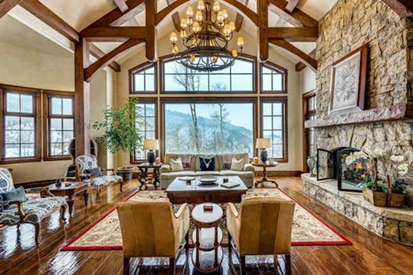 A rustic living room with a view of the Colorado mountains.