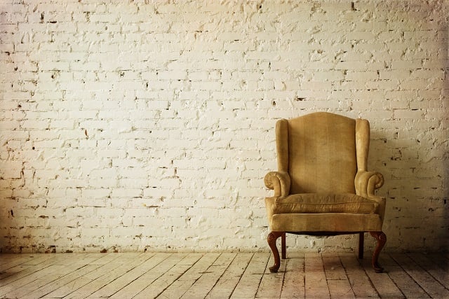 Old Retro Armchair against Blank White Wall.