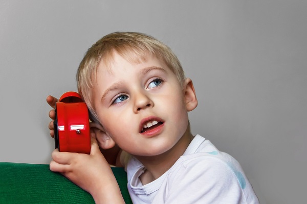 boy investigating the sounds of an alarm clock