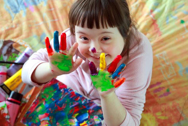 Cute little girl with painted hands