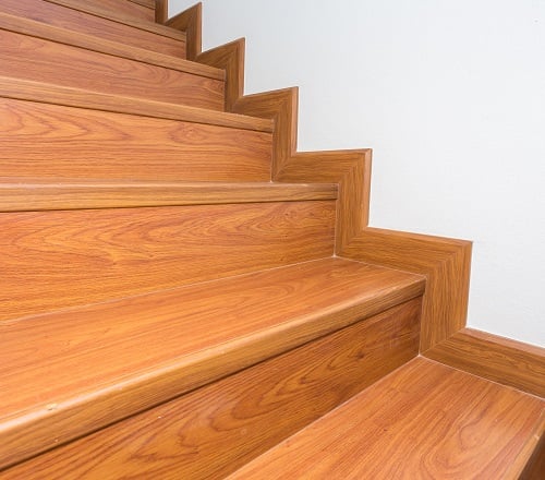 wooden staircase made from laminate wood in white modern house