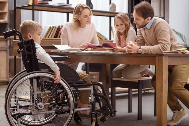 happy parents teaching children at home