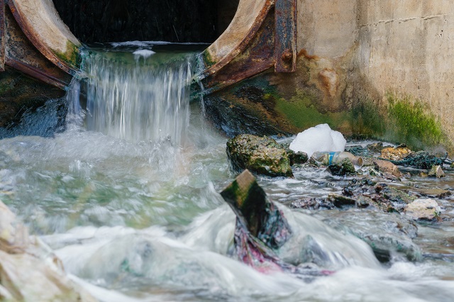 Pollution drain flowing stream to a canal.