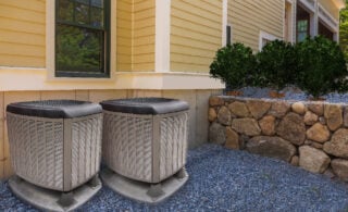 heat pump surrounded by backyard garden