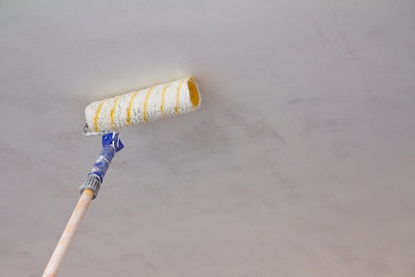 Close up of painting a ceiling with roller