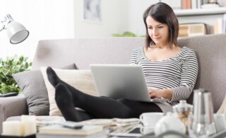 Woman at home working on her laptop