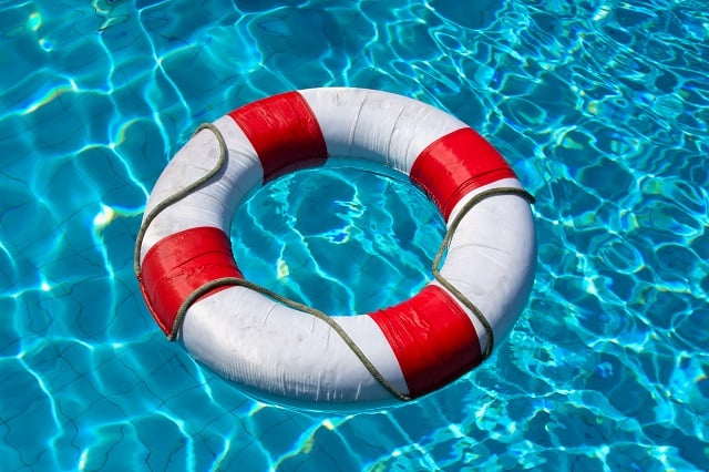 Safety life buoy in blue swimming pool