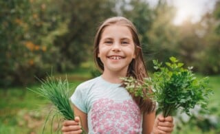 Girl holding non-poisonous plants/herbs outside