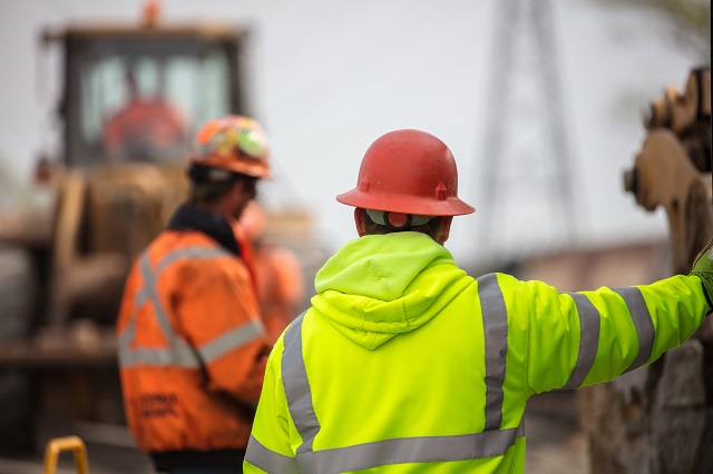 Construction workers on site on a cloudy day