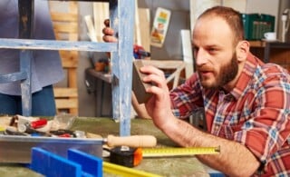 Handyman polishing wooden surface