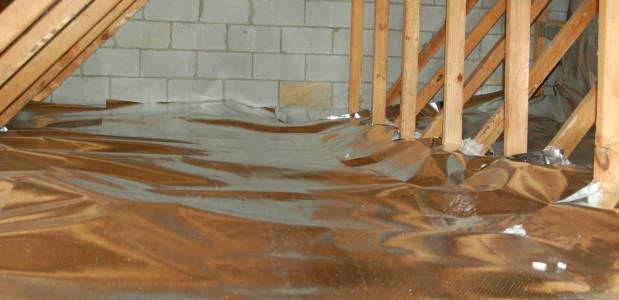 The foil-faced insulation behind this fireplace provides an air barrier and  thermal shield.