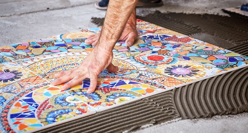 process of laying floor ceramic tiles, installation of tiles on the glue