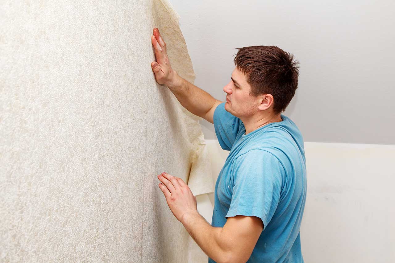Worker smoothing out new wallpaper