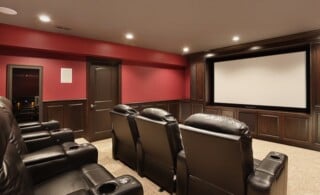Theater in luxury home with red walls