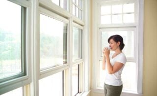 Woman drinking coffee and looking out the window