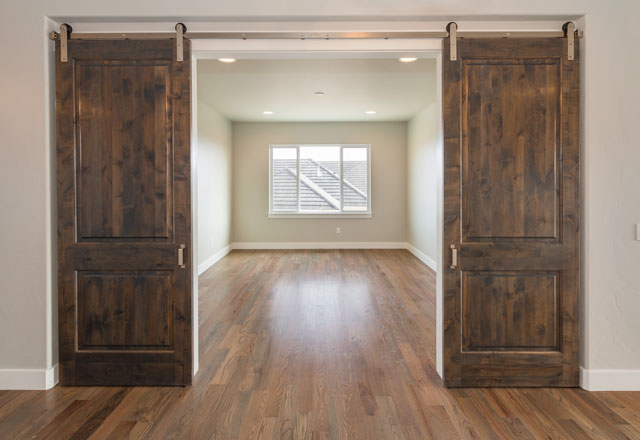 Dark wood interior barn doors slid open