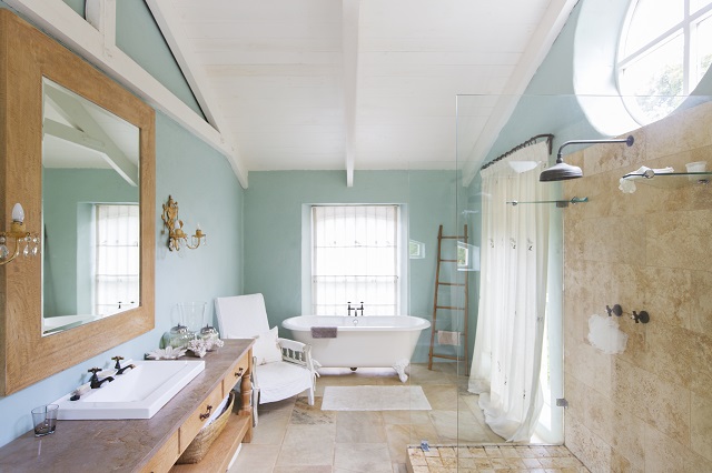 Bathtub and shower in spacious farmhouse or rustic bathroom