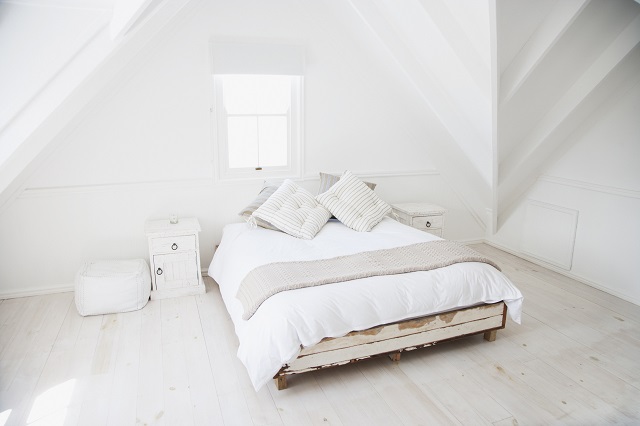 Country style bedroom with distressed wooden bedframe