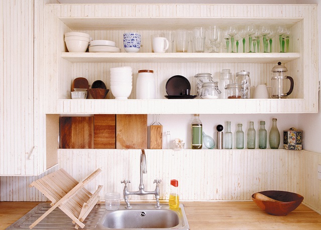 Rustic looking kitchen with open shelving above the sink