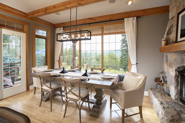 Dining room with thick pedestal table and upholstered chairs